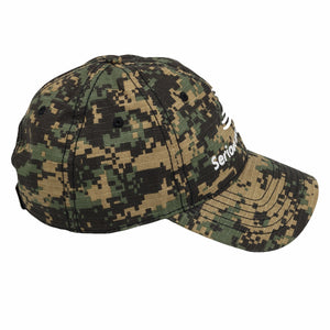 A camouflage baseball cap with the embroidered Serious Detecting logo on the front on the side