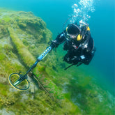 Person Treasure hunting under water with the minelab waterproof Excalibur II detector