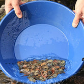 Two hands holding a Gold Prospecting Bowl Shifting through gravel 