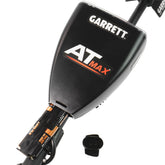The Garrett AT Max metal detector control pod shown with its battery compartment open and 4 double A batteries inside.   