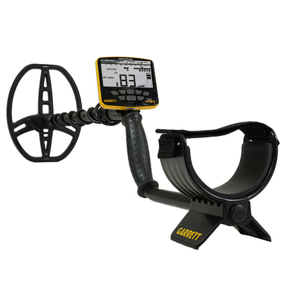 Garrett metal detector with a black coil, digital display screen, and black armrest with strap on a white background.