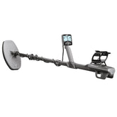 A handheld metal detector with a large circular coil, long shaft, digital display screen, and armrest, shown against a plain white background.
