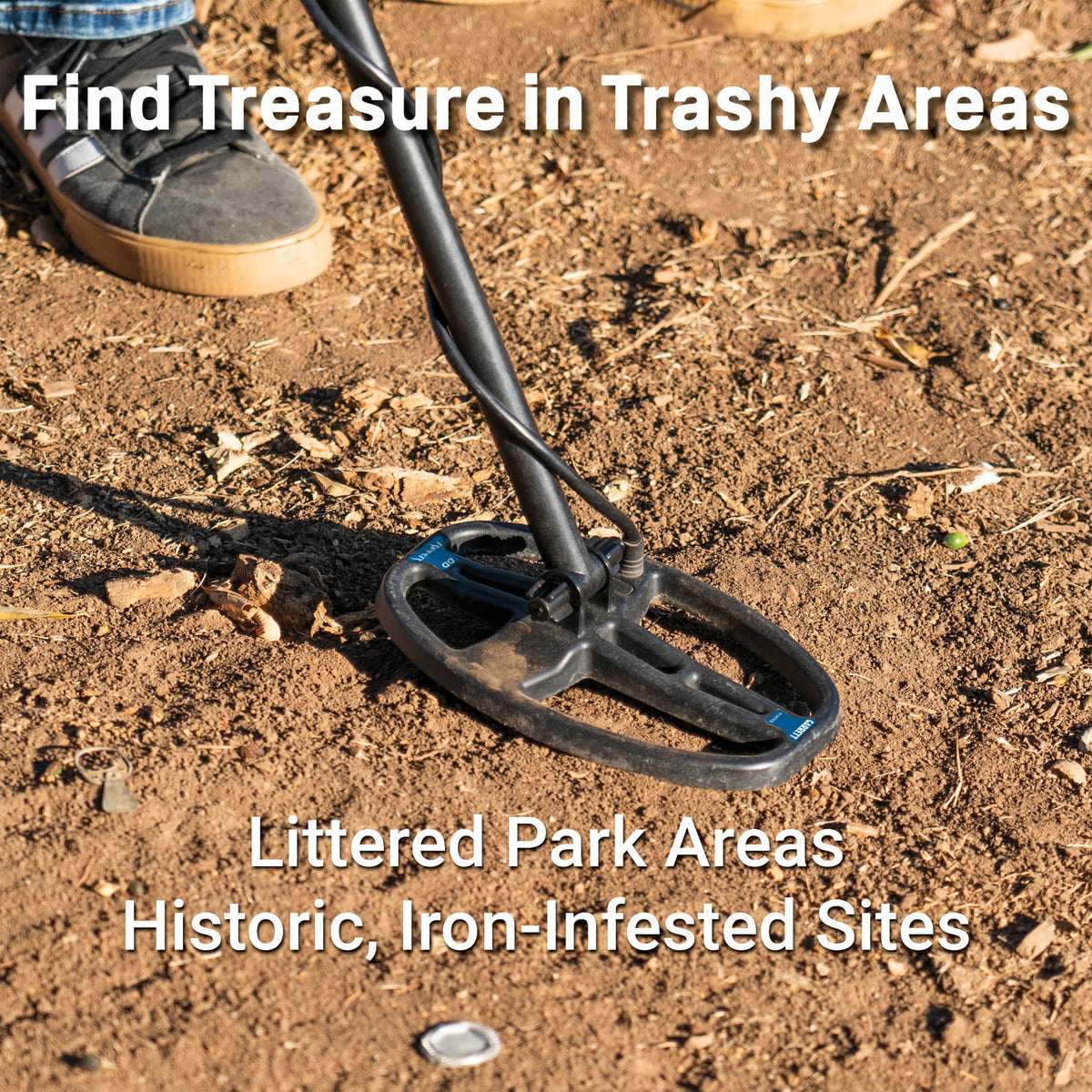 Metal detector coil shown on a dusty dirt field with text about finding treasure in littered parks, historic areas and iron-infested sites