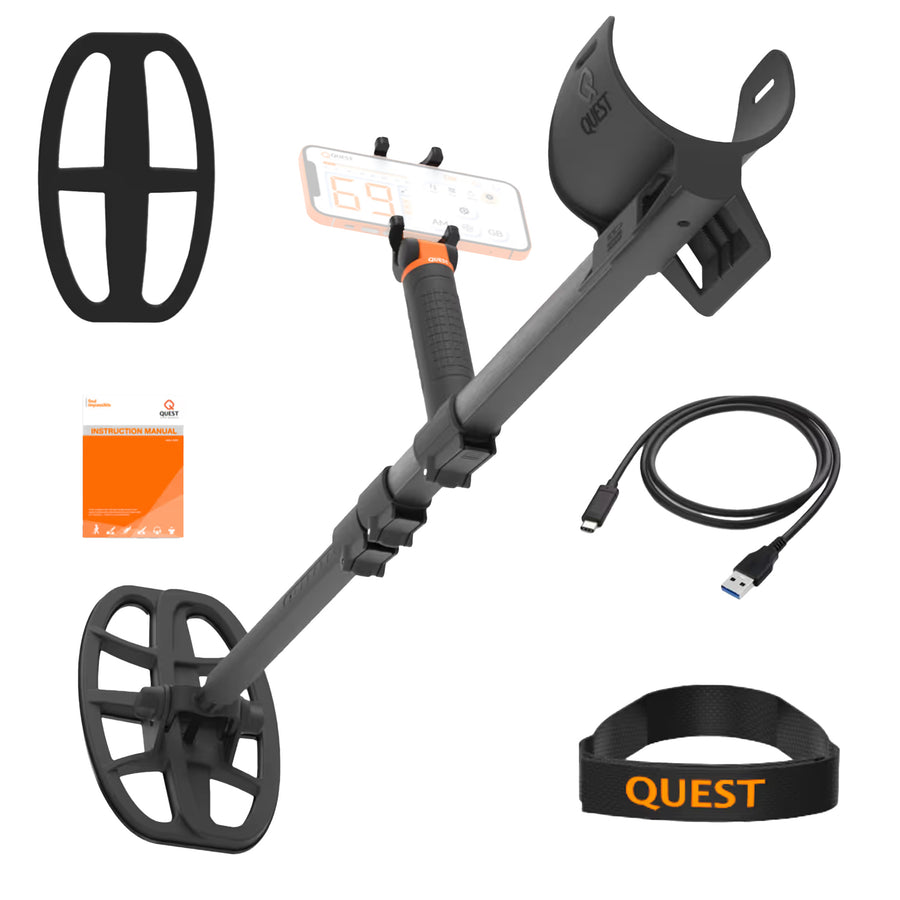 Black metal detector set with a smartphone mount, coil, USB charging cable, orange booklet, and black wristband with orange QUEST branding, shown on a white background.