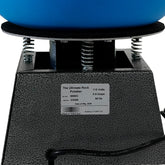 Close-up of a rock polisher machine with a black textured base, silver springs, a blue grinding bowl, and a white product label reading 'The Ultimate Rock Polisher' with specifications.