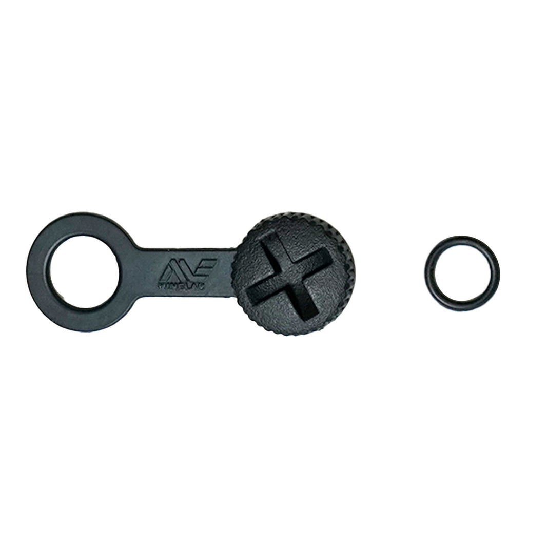 A black plastic cap with tether and a separate small O-ring to the right, shown on a plain white background.