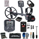 A metal detector kit laid out on a white background, including a gray and black Minelab Ultra metal detector with coil, handheld controller, headphones, battery, charger, accessories, gloves, shovel, and carrying bag. The Minelab brand is visible on multiple items.