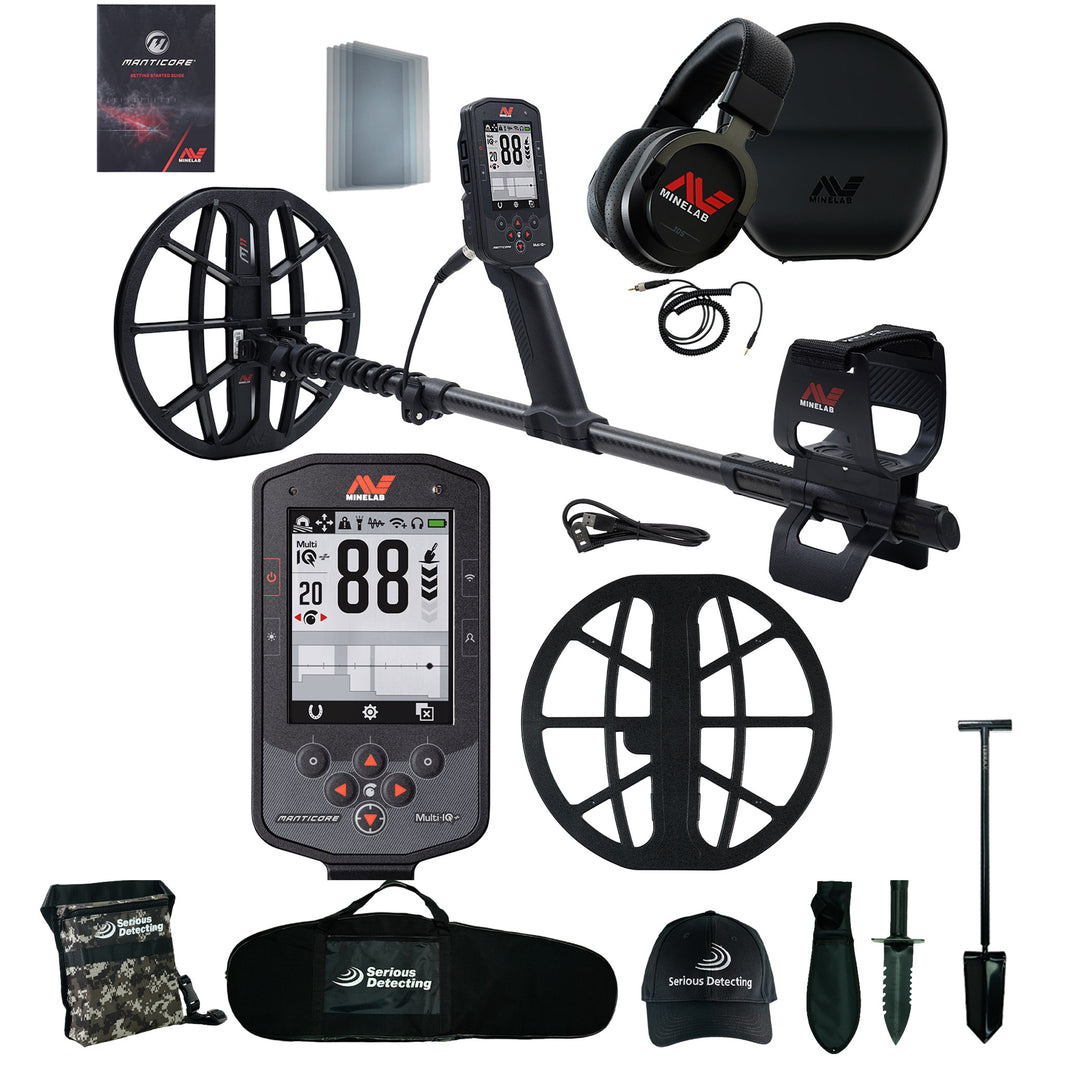 Minelab Manticore metal detector with gray coil, black shaft, digital display,  arm cuff assembly, and Serious Detecting kit including a camo pouch, black carry bag, hat, digger with sheath, and shovel, shown against a white background