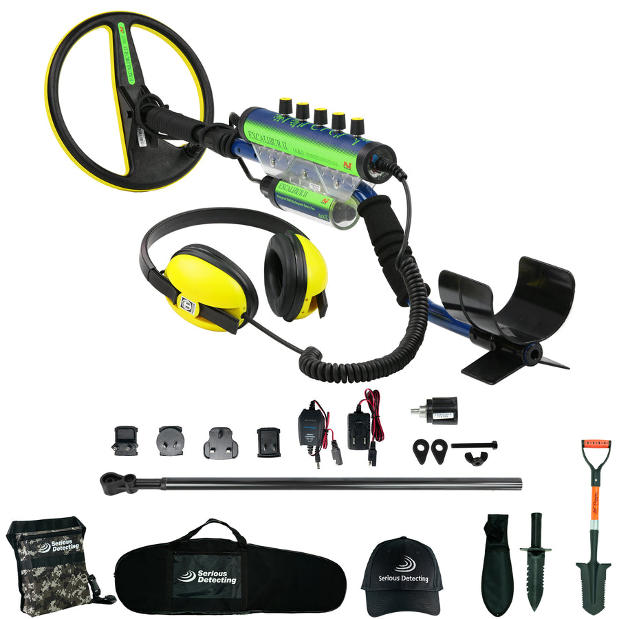 A metal detector kit with a blue and black control box, yellow and black headphones, a black carrying case, accessories, and tools including a shovel, digger, and cap on a white background.
