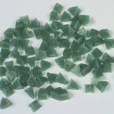 Raytech green pyramid tumbling media showing angular pyramid-shaped abrasive pieces