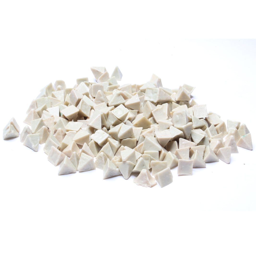 Close-up view of Raytech white ceramic pyramid media pieces for vibratory tumblers