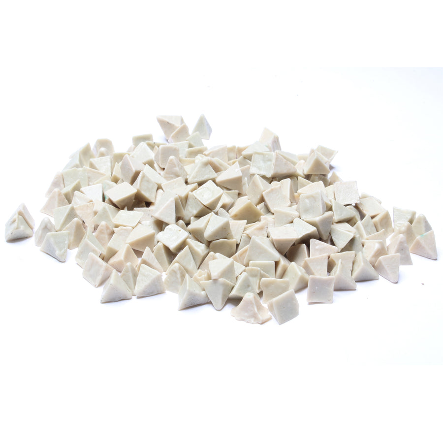 Close-up view of Raytech white ceramic pyramid media pieces for vibratory tumblers