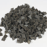 Raytech grey brown pyramid tumbling media showing angular pyramid-shaped pieces