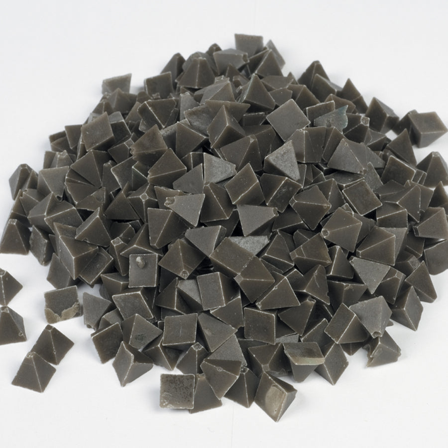 Raytech grey brown pyramid tumbling media showing angular pyramid-shaped pieces