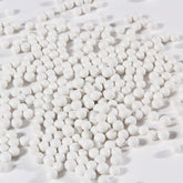 Close-up of white porcelain balls ceramic tumbler media for jewelry polishing