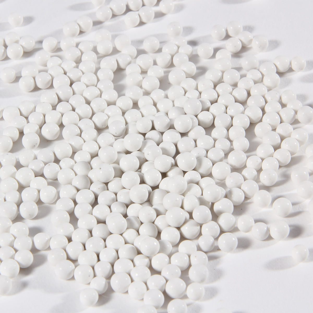 Close-up of white porcelain balls ceramic tumbler media for jewelry polishing