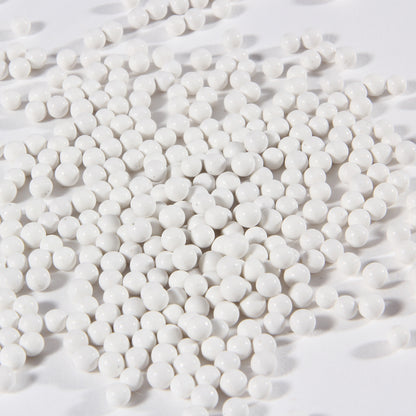Close-up of white porcelain balls ceramic tumbler media for jewelry polishing
