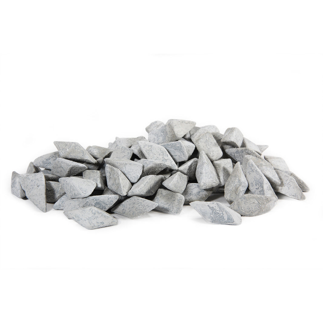 Close-up of Raytech polyhedron ceramic media pieces showing textured aluminum oxide surface for titanium finishing