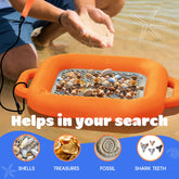 An orange handheld seashell and shell specimen finder with a metal mesh tray is shown in shallow water with a person's hands above it, plus text reading 'Helps in your search' and icons for shells, treasures, fossil, and shark teeth.
