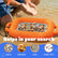 An orange handheld seashell and shell specimen finder with a metal mesh tray is shown in shallow water with a person's hands above it, plus text reading 'Helps in your search' and icons for shells, treasures, fossil, and shark teeth.