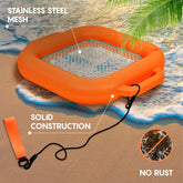 An orange inflatable sifting float with a stainless steel mesh center, shown on a beach with text callouts reading 'STAINLESS STEEL MESH', 'SOLID CONSTRUCTION', and 'NO RUST'.