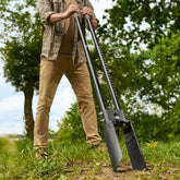 Man holding the CKG Heavy Duty Post Hole Digger pointing at an angle with measurements on pole