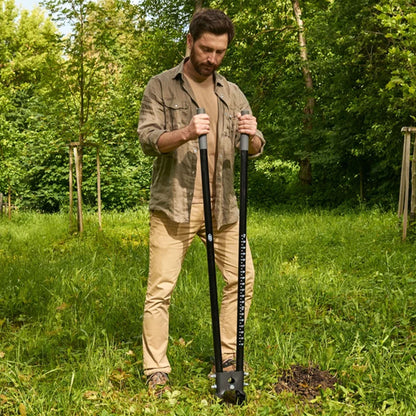 Man using the CKG Heavy Duty Post Hole Digger.  Inserted into the ground.