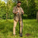 Man using the CKG Heavy Duty Post Hole Digger.  Inserted into the ground.
