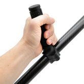 Hand holding a black pull handle against a white background