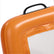 Close-up of an orange floating beach sifter upright with a black handle on a white background