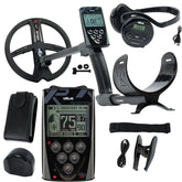 A black metal detector kit with a large coil, handheld controller, headphones, belt clip, battery, carrying case, and accessories, arranged on a white background. The main device shows the brand name 'DEUS'.