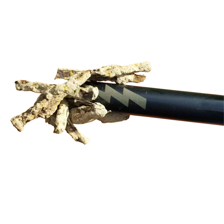 Close up of the magnetic probe grabbing iron covered with dirt