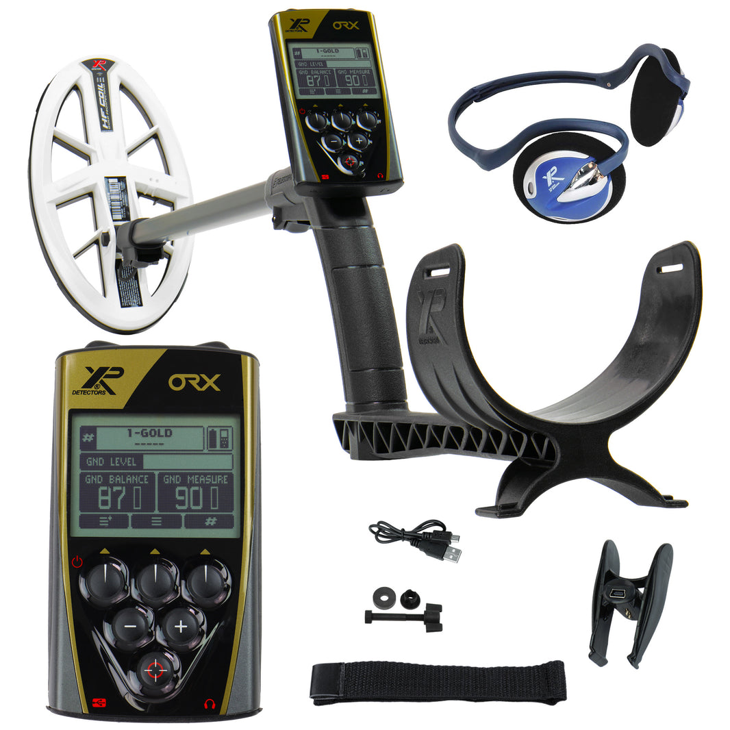 XP ORX metal detector kit with a black and gold handheld unit, white coil, headphones, USB cable, strap, and small accessories on a white background.