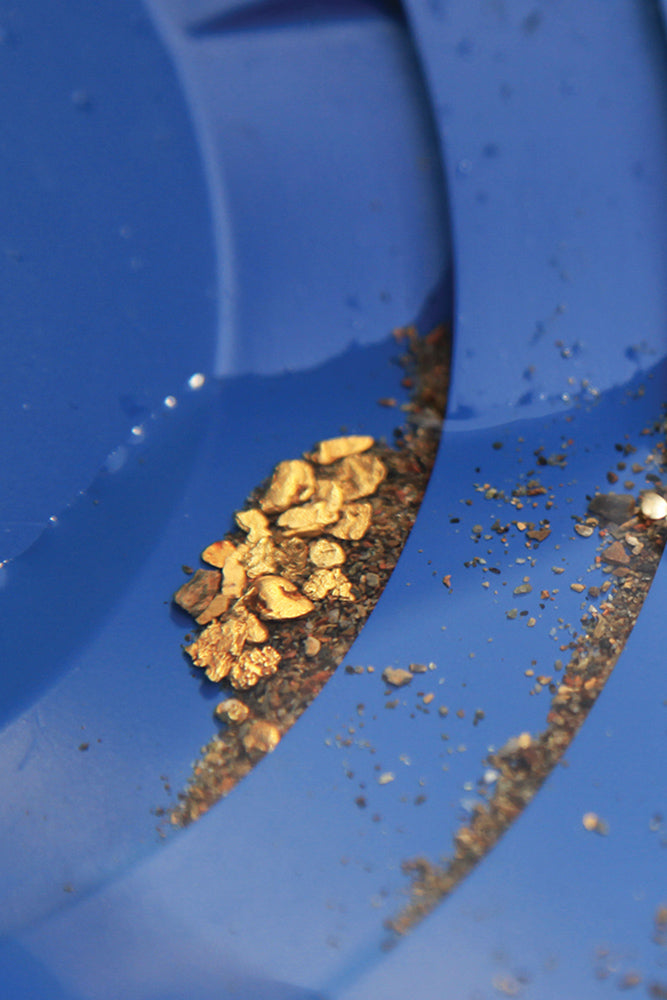 Close-up of gold and silver flakes on a blue surface