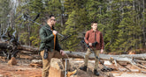 A man and his son with Nokta Score metal detectors in a forest setting along with a Nokta Premium Shovel