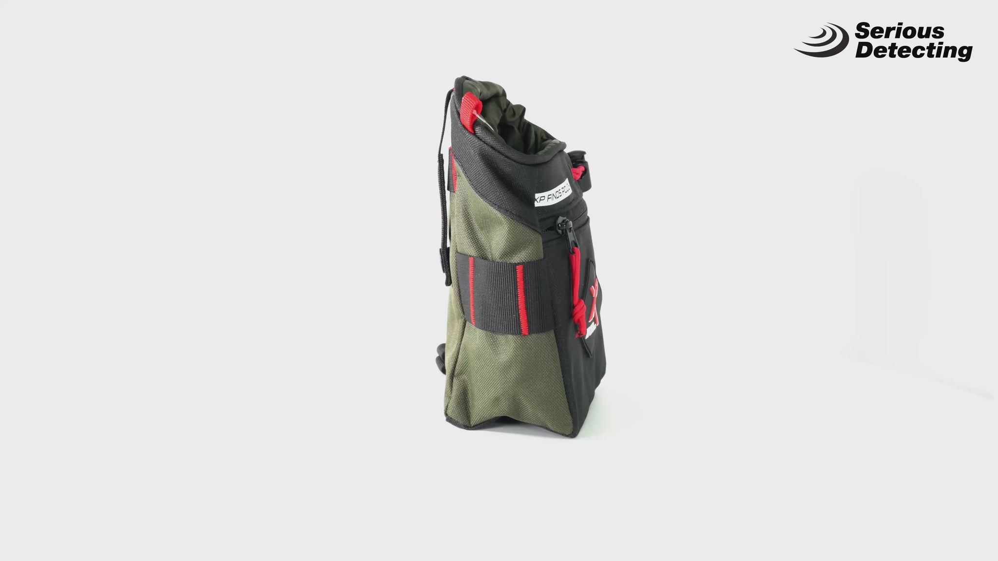 A green and black XP Metal Detectors Finds Pouch with red straps and a Molle attachment system, designed for carrying metal detecting equipment in a 360 spin demo
