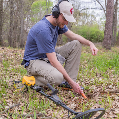 Detectorist recovering a target with the Garrett Pro-Pointer AT Z-Lynk and MS-3 wireless headphones in the field