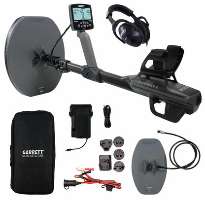 Garrett Axiom pulse induction metal detector with dual coils, control box, MS-2 headphones, and carrying bag on desert ground