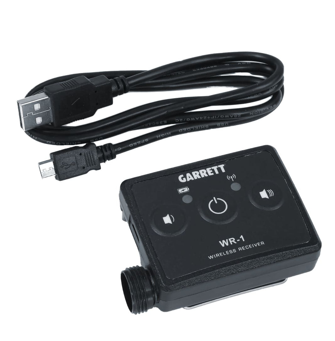 Garrett Z-Lynk wireless system transmitter and receiver units with headphones on soil ground