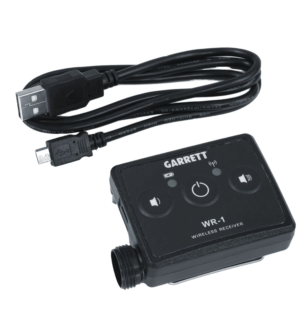 Garrett Z-Lynk wireless system transmitter and receiver units with headphones on soil ground