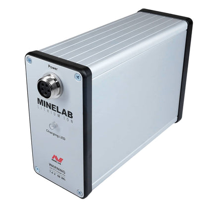 A Minelab lithium ion battery designed for powering metal detectors, with built-in amplifier. The battery is primarily silver with black and gray accents, featuring the Minelab brand logo and product information. Side view