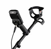 Close-up of the Minelab Manticore armrest and control pod rear showing the charging port and headphone connection