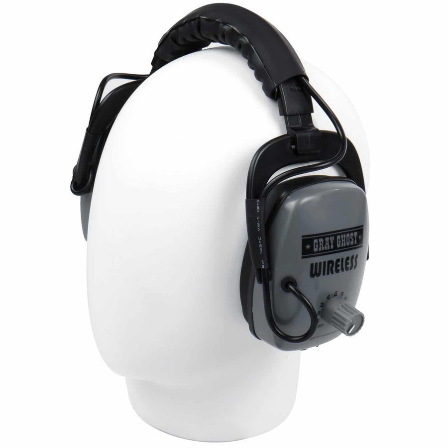 Side view of gray Wireless earcup with padded black headband on a display head