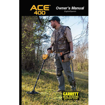 The cover of the English/Spanish version of the Garrett ACE 400 digital owner's manual, depicting a male detectorist in a grassy field. 