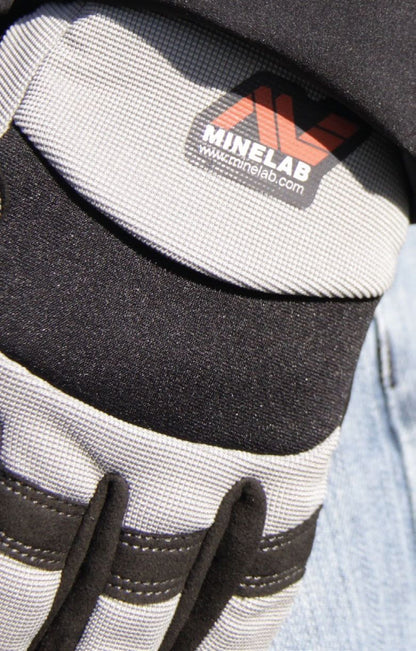 Close-up of the Minelab digging glove back showing the Minelab logo and stretch fabric