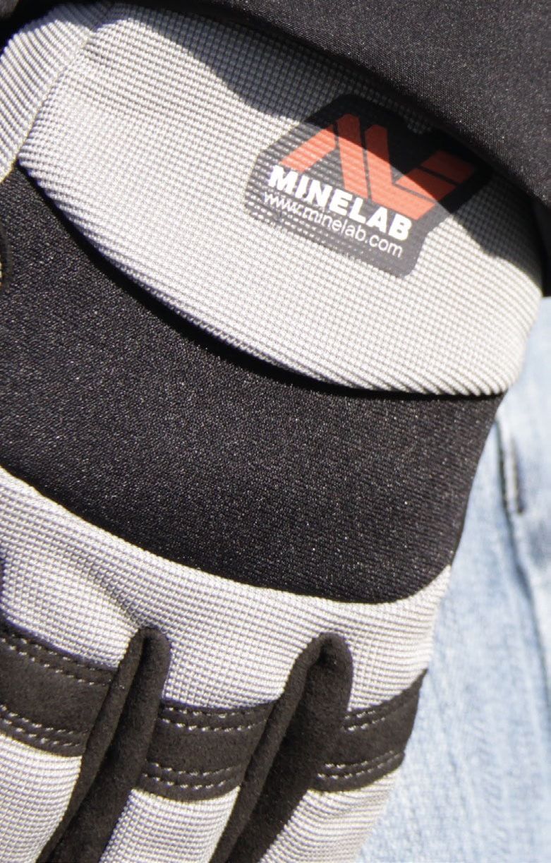 Close-up of the Minelab digging glove back showing the Minelab logo and stretch fabric